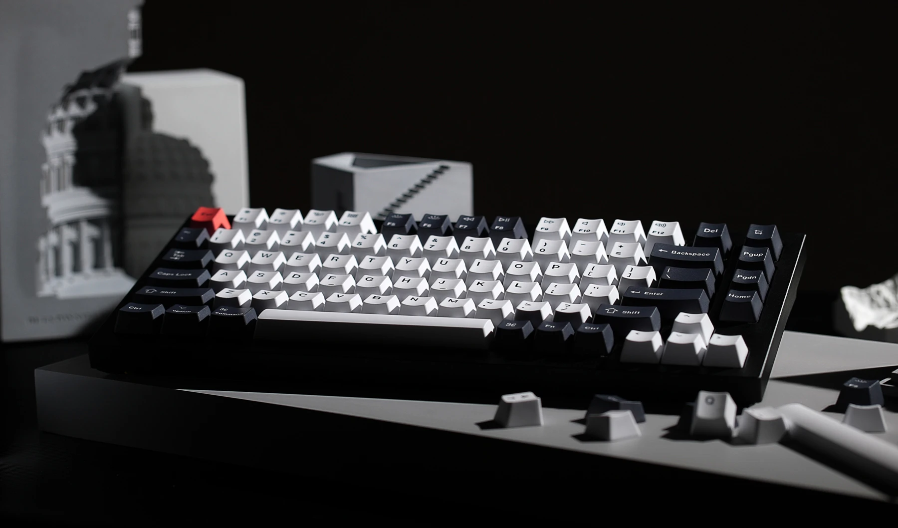 The Keychron Q1 keyboard with some extra keycaps laying on top of a desktop