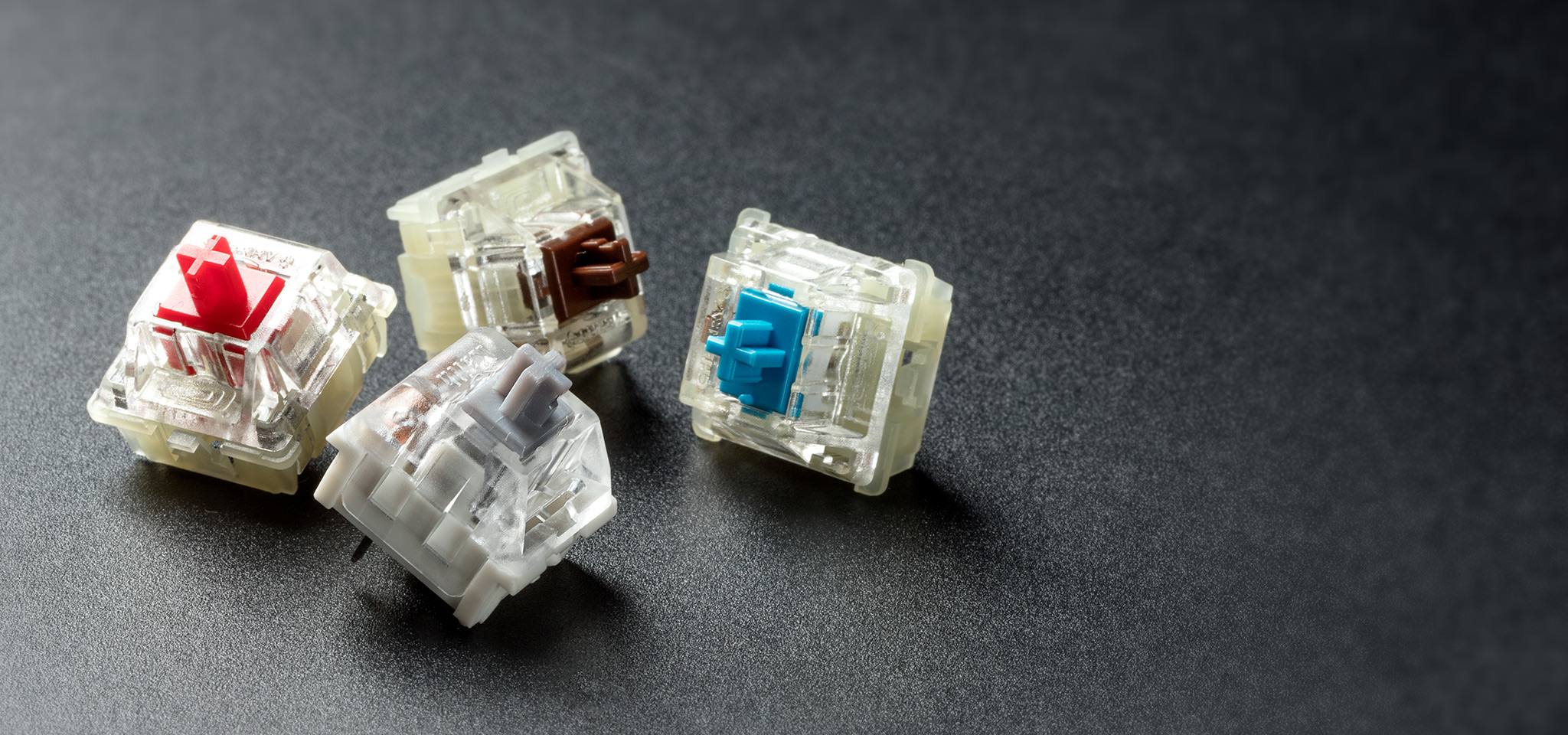 HyperX red, brown, blue and silver switches spread over a table